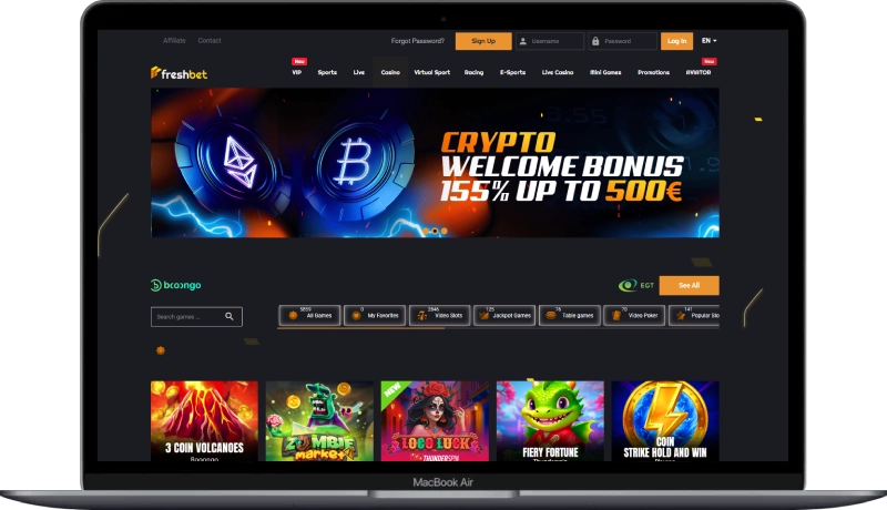 A laptop mockup shows the Freshbet homepage with a large crypto welcome banner, provider logos, search and filter controls, and a carousel of slot thumbnails featured within the Freshbet Casino Review coverage, emphasising site layout and navigation elements